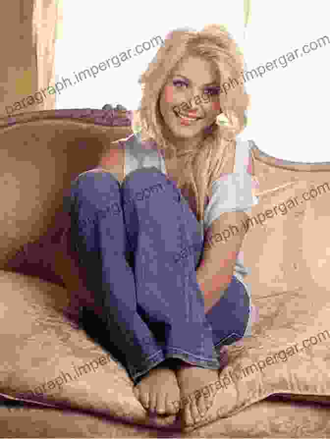 Hollywood Blonde, A Woman With Long Blonde Hair And Blue Eyes, Is Sitting On A Couch, Smiling. She Is Wearing A White Dress And Has A Book In Her Hand. Deep Thoughts From A Hollywood Blonde